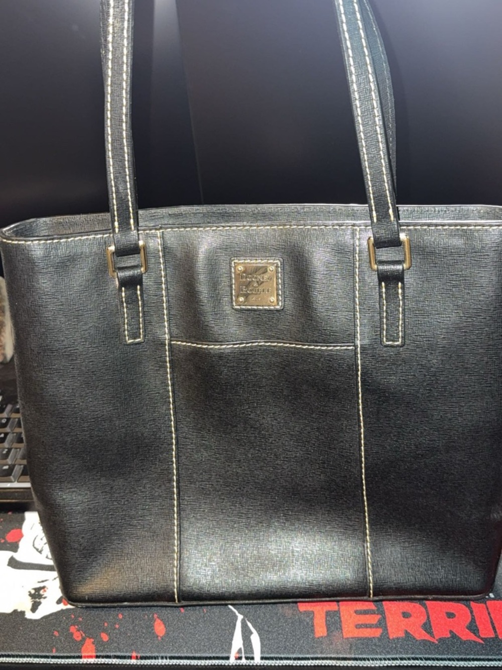 Dooney & Bourke Black Leather Tote with Cream Contrast Stitching and Gold Plaque